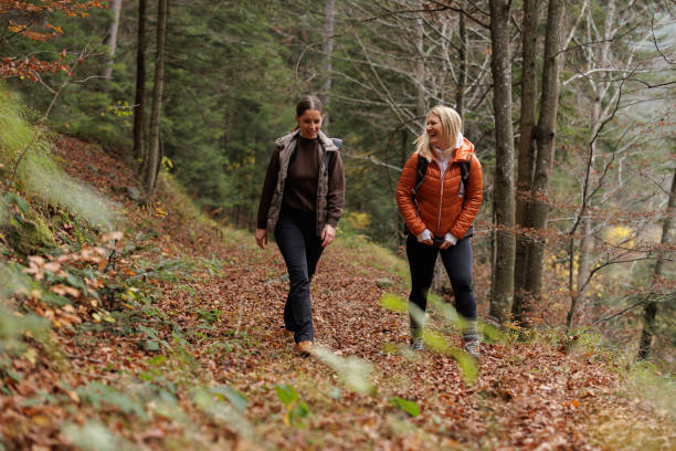 istock Two Women Enjoying a Scenic Hike Through Autumn Forest 2184602010