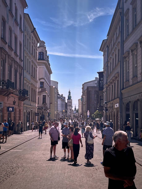 Krakow, Poland - July 31, 2024 : Street view of pedestrians and tourists in downtown