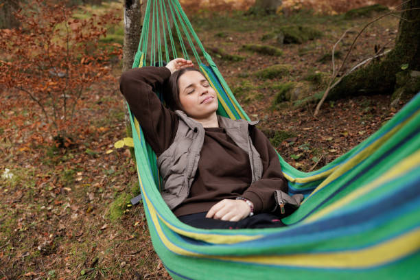 istock Tranquil Autumn Day Relaxing in a Hammock by a Forest Stream 2184602820
