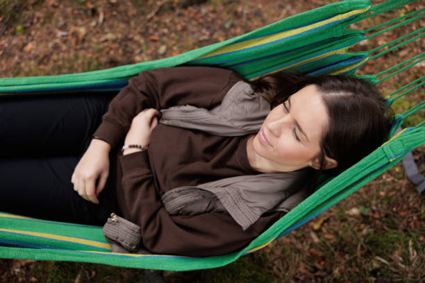 istock Tranquil Autumn Day Relaxing in a Hammock by a Forest Stream 2184602907