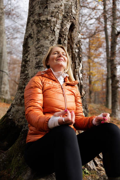 istock Woman Meditates Peacefully in Autumn Forest Setting 2184603250
