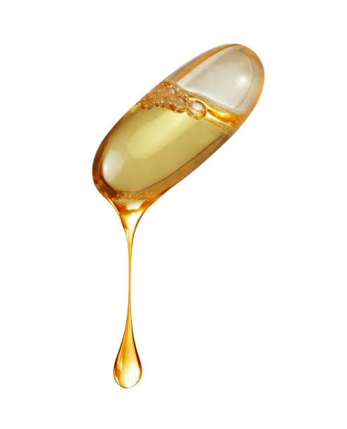 istock Drop is dripping from capsule with fish oil close up isolated on white background 2184603626