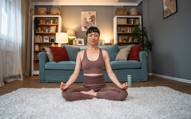 istock Woman meditating at home 2184605586