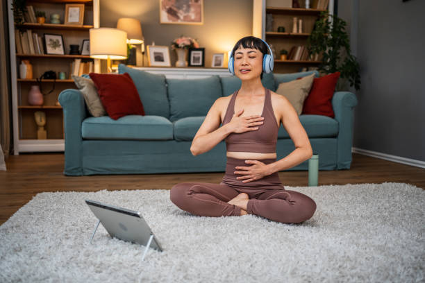 istock Woman watching a yoga workout video 2184606477