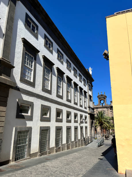 istock Colorful ancient landscape view with typical colonial style building with iron balcony in main square against blue sky. On back, Cathedral Santa Ana Vegueta in Las Palmas de Gran Canaria, Canary Island, Spain. 2184607355