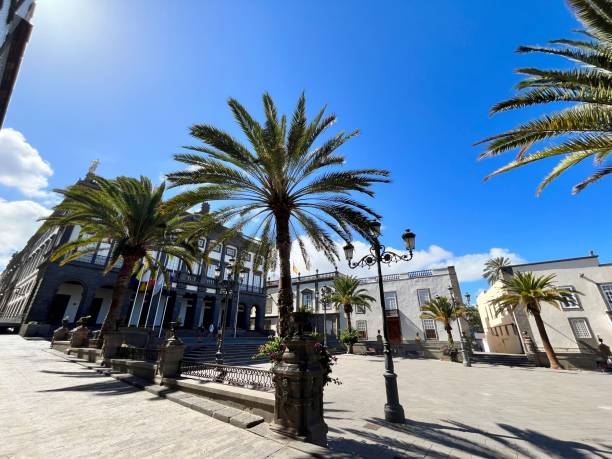istock Colorful ancient landscape view with typical colonial style building with iron balcony in main square old town against blue sky. On right is situated Cathedral Santa Ana Vegueta in Las Palmas de Gran Canaria, Canary Island, Spain. 2184607389