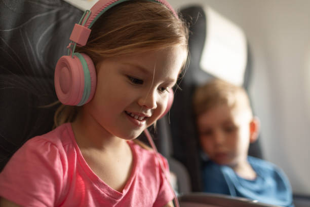 istock Happy children flying on airplane. 2184608859