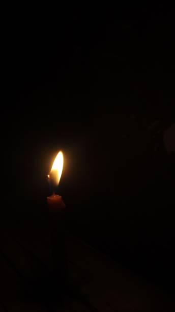 istock Candlelight in the dark background negative space 2184610289