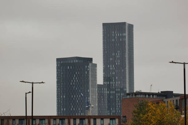 istock Three Grey Buildings Against a Hazy Sky in Manchester 2184612301