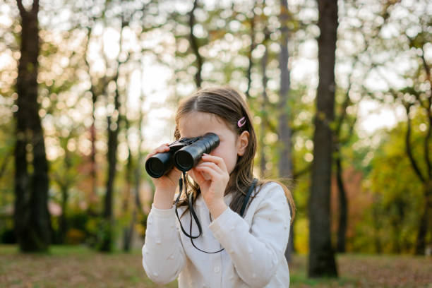 istock Girl with binoculars in nature 2184613090