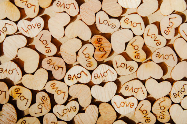 Heart shapes with love text on a craft paper background Wooden heart Love concept Monochrome template 14 february Textured surface