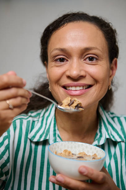 istock Smiling woman enjoying a healthy breakfast with cereal 2184616499