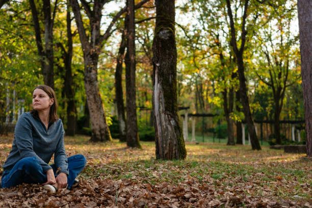 istock A woman is sitting in the park 2184616784