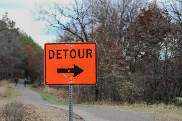 istock orange detour sign in a park setting background 2184618886