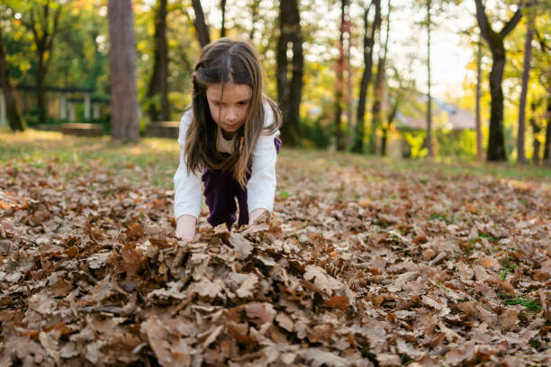 istock Girl playing whit autumn leaves 2184620103
