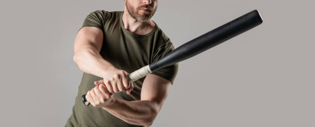 istock cropped view of angry man express anger with bat isolated on grey background. 2184621015