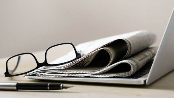 istock Pile of newspapers stacks on table 2184622516