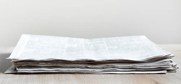 Pile of newspapers stacks on table