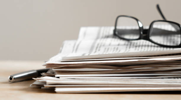 istock Pile of newspapers stacks on table 2184622643