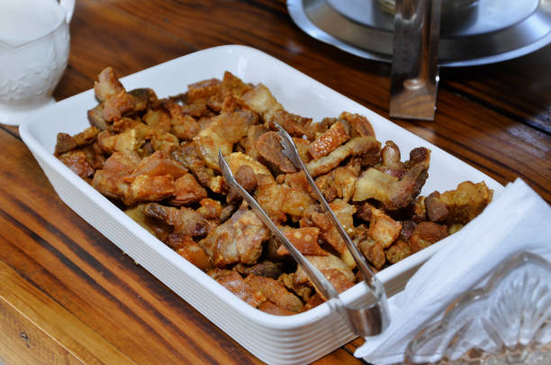 A white plate with delicious fried pork rinds for lunch