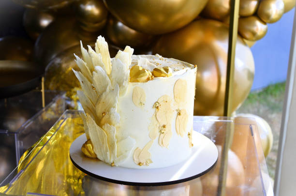 istock Beautiful white chocolate modern design cake under table for party 2184624470