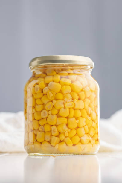 istock Canned sweet corn in jar on white table. 2184626683