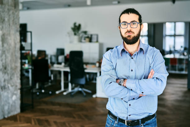 istock Confident male professional looking at camera standing at startup office 2184627848