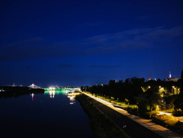 Warsaw skyline is lit up at night, with a river running through the middle. Warsaw, Poland 01.06.2024