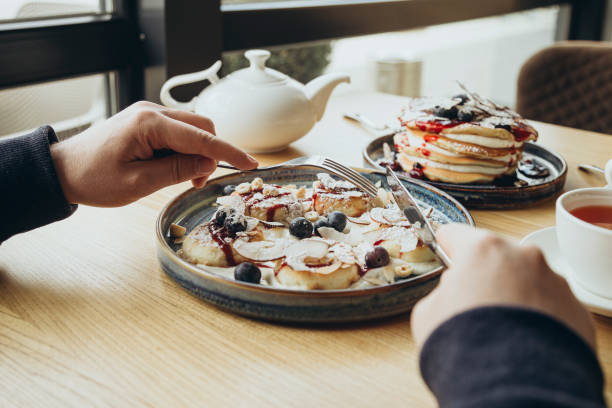 istock A man eats cheesecakes in a cafe for breakfast, a traditional Ukrainian dish. 2184628217