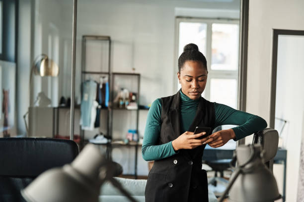 istock Young businesswoman using mobile phone in office 2184628390