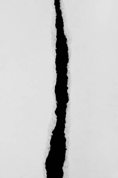 istock Torn White Paper Sheet  Revealing Black Background 2184629474