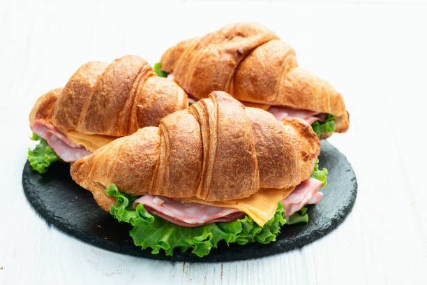 istock Croissant sandwich with salad ham and cheese . Top view 2184629729