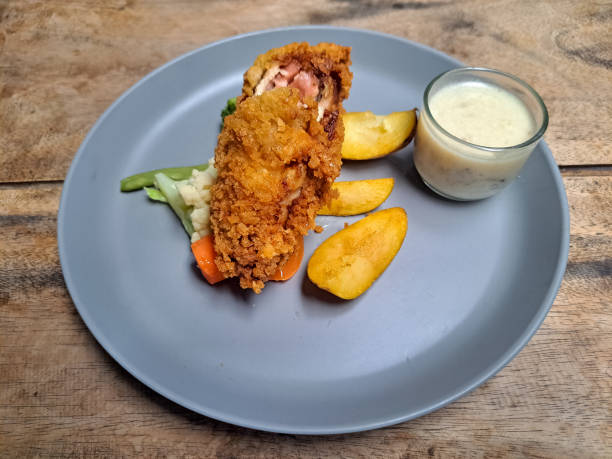 Yummy Chicken Cordon Bleu With Potato Wedges, Snow Peas, Brocolli, Carrot And Mushroom Sauce. Food Menu.