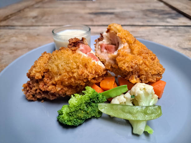 Chicken Cordon Bleu With Potato Wedges, Snow Peas, Brocolli, Carrot And Mushroom Sauce. Food Menu.