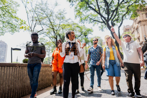 istock Tour guide explaining to tourists in the city 2184633307