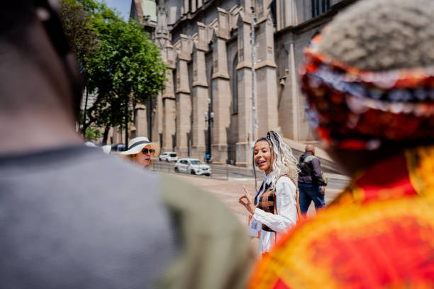 istock Tour guide explaining to tourists in the city 2184633327