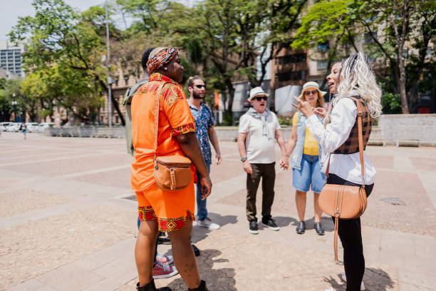 istock Tour guide explaining to tourists in the city 2184633330
