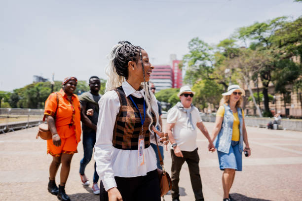 istock Tour guide walking while explaining to tourists in the city 2184633334