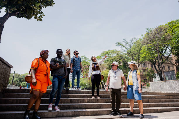 istock Tour guide explaining to tourists in the city 2184633348