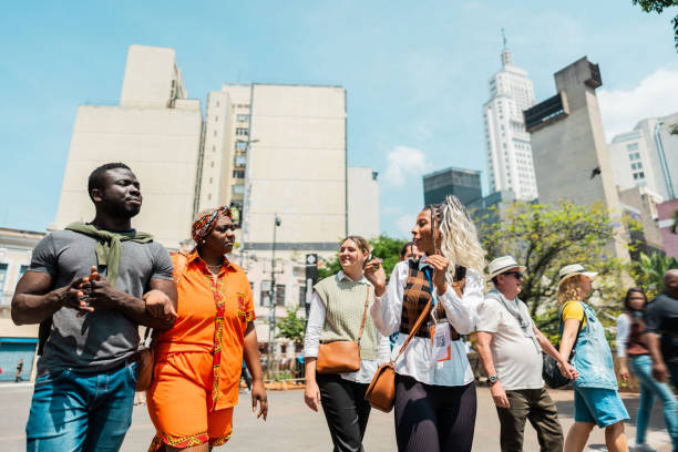 istock Tour guide walking while explaining to turists in the city 2184633878