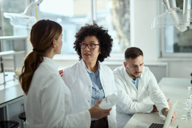 istock Group of chemist talking about scientific research in laboratory. 2184634010