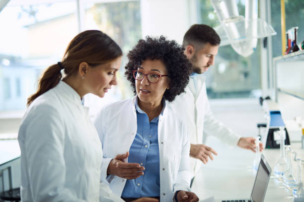 istock Group of chemist talking about scientific research in laboratory. 2184634046