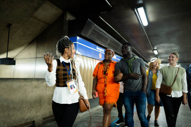 istock Tour guide walking while explaining to tourists in the subway station 2184634086