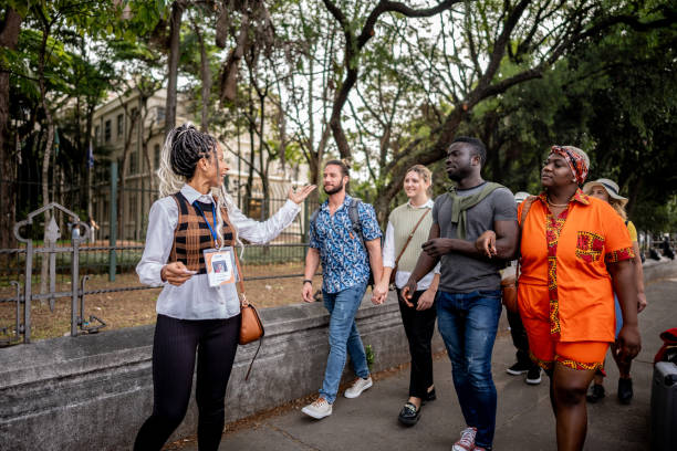 istock Tour guide walking while explaining to tourists in the street 2184634126