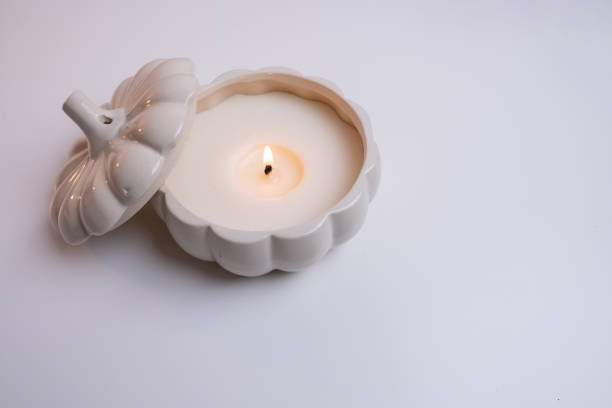 istock Burning candle on white table. Home comfort, spa, relaxation and wellness concept. Interior decoration. Relaxation and zen atmosphere 2184634642