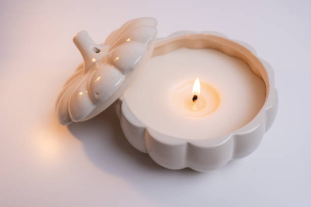 istock Burning candle on white table. Home comfort, spa, relaxation and wellness concept. Interior decoration. Relaxation and zen atmosphere 2184634647