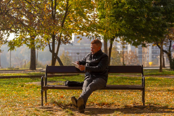 Entrepreneur checking his business finance on line while walking on city streets