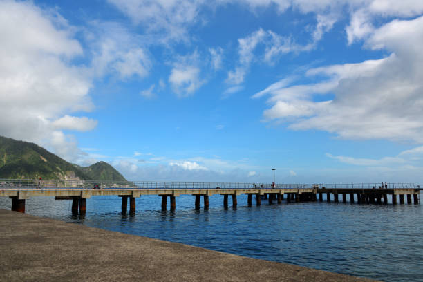Roseau, Dominica: cruise pier and coastal mountains. Morne La Falaise (left), Morne La Vue (right) - SW coast of Dominica.