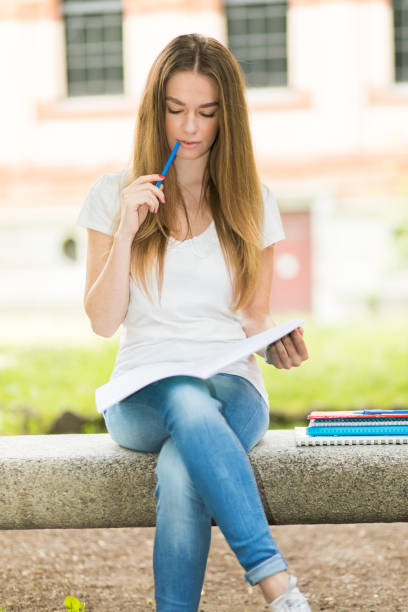 istock Young student girl sitting and thinking on university campus 2184636957