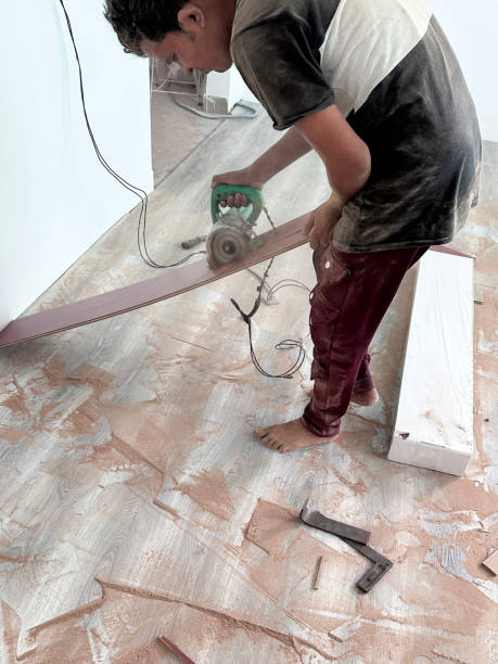 istock Image of skilled carpenter using electric saw, precise timber cutting, laminate flooring installation / crafting wooden floors with expertise and efficiency 2184637071